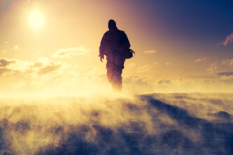 Man standing on top of a mountain. Dramatic scenery.